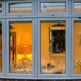 A close up of bay windows looking into a dining area
