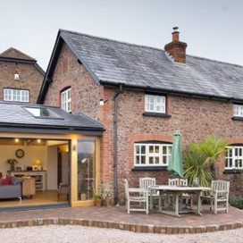 An external view of Origin's windows and doors on an extension to a converted barn, shown here fully opened