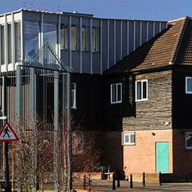An external shot of the Royals building, showing the original building and the new aluminium windows added to the roof