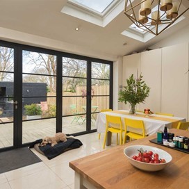 View of inside a dining room with closed steel frame bifold doors
