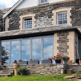 Outside of a modern home fitted with closed bifold doors