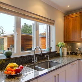 A close up of the Origin windows used in a kitchen, looking out into the garden