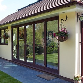 A view of an extension from the garden, showcasing the use of large glass doors