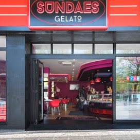 An exterior shot of Sundaes Gelato showing the storefront windows and doors supplied by Origin