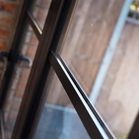 Close up of bifold doors looking over a bright garden