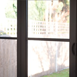 Close up of bifold doors looking over a bright garden