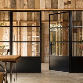 Black bifold doors leading out of the cafe