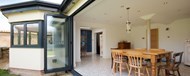 Origin bifold doors fully open looking into the kitchen and dining area