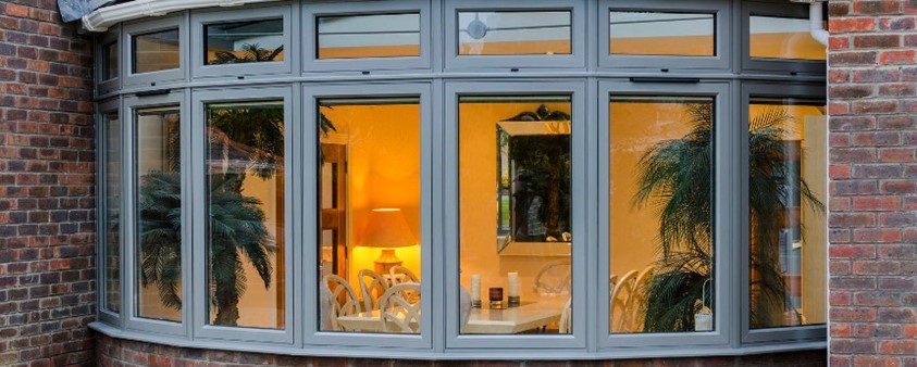 A close up of bay windows looking into a dining area