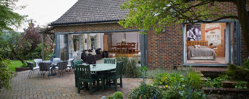 The view from the garden into a property with different types of patio doors