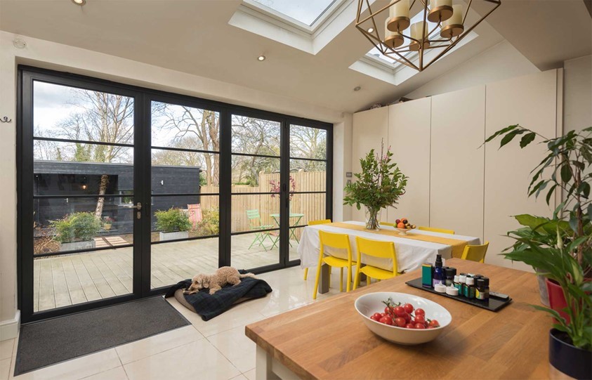 View of inside a dining room with closed steel frame bifold doors