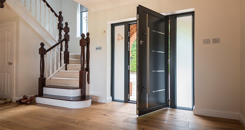 An open black bifold door from the inside of a home 