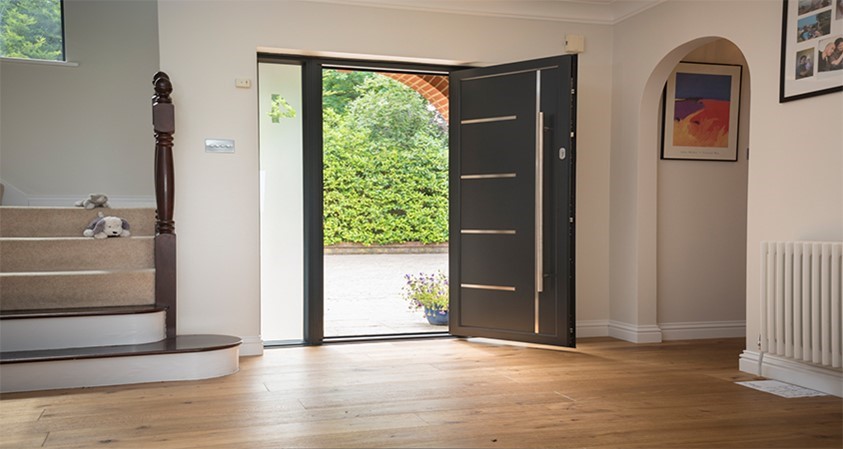 Inside of a modern home with an open Origin front door leading onto the front