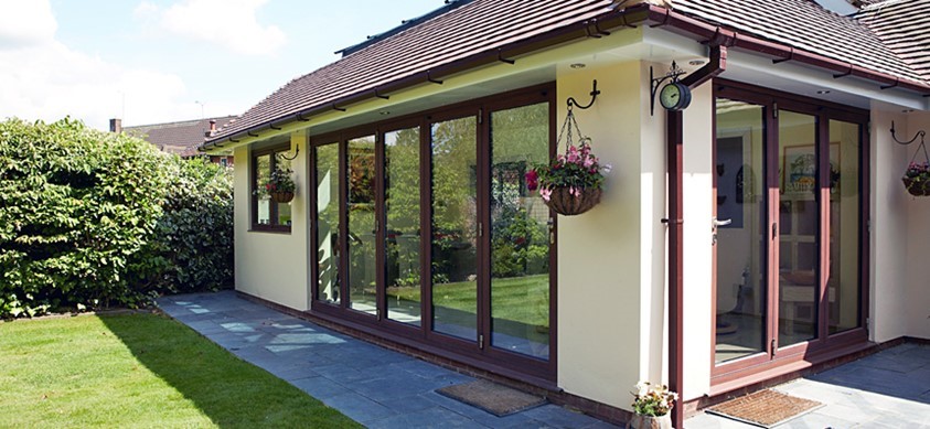 A view of an extension from the garden, showcasing the use of large glass doors