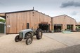 Outdoor of a farm shop with a blue tractor parked outside